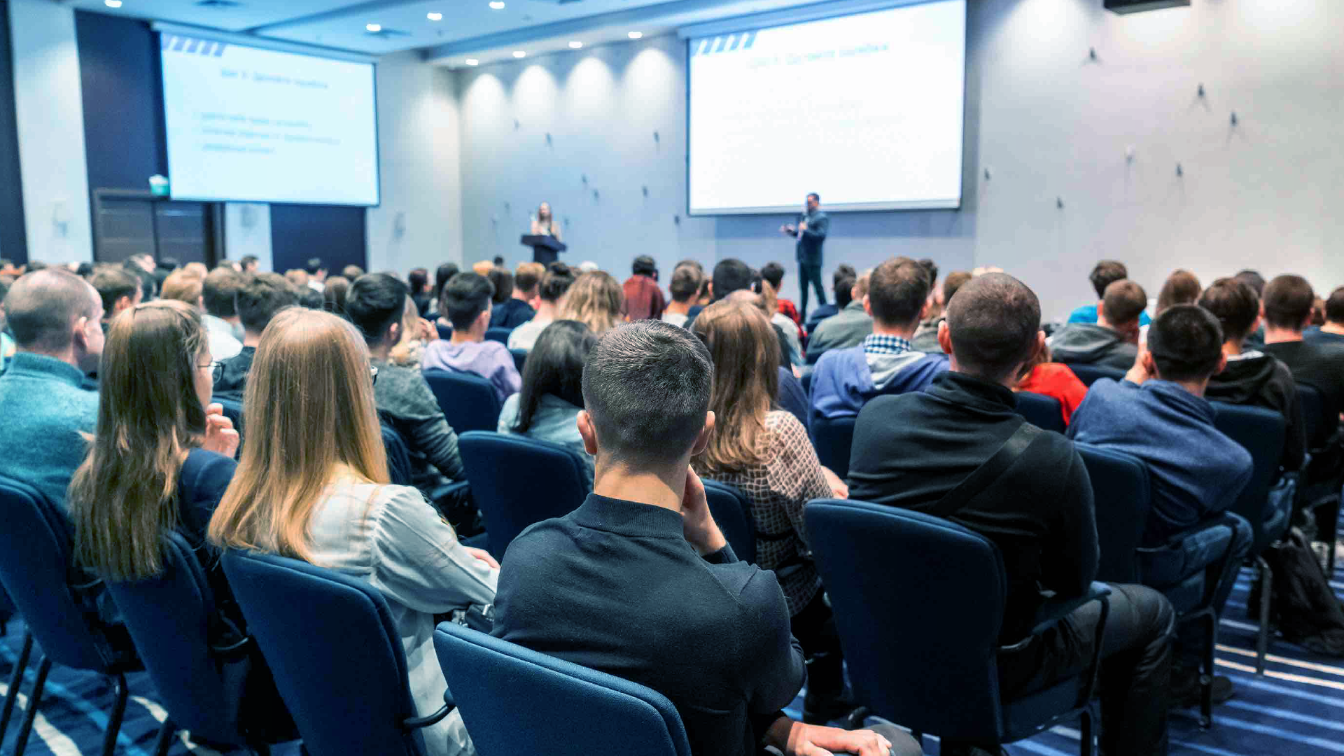 Audience attending a presentation at a professional conference.