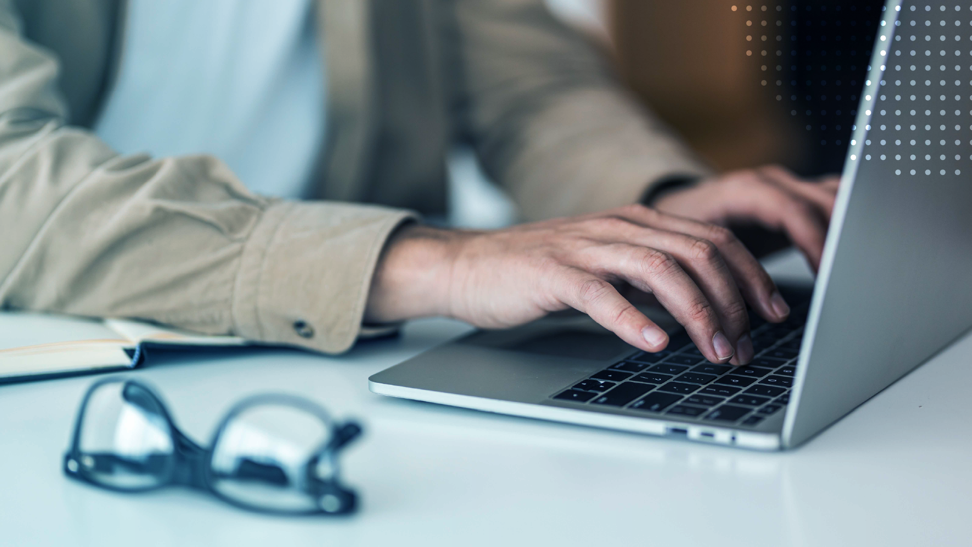 Close-up of a person typing on a laptop.