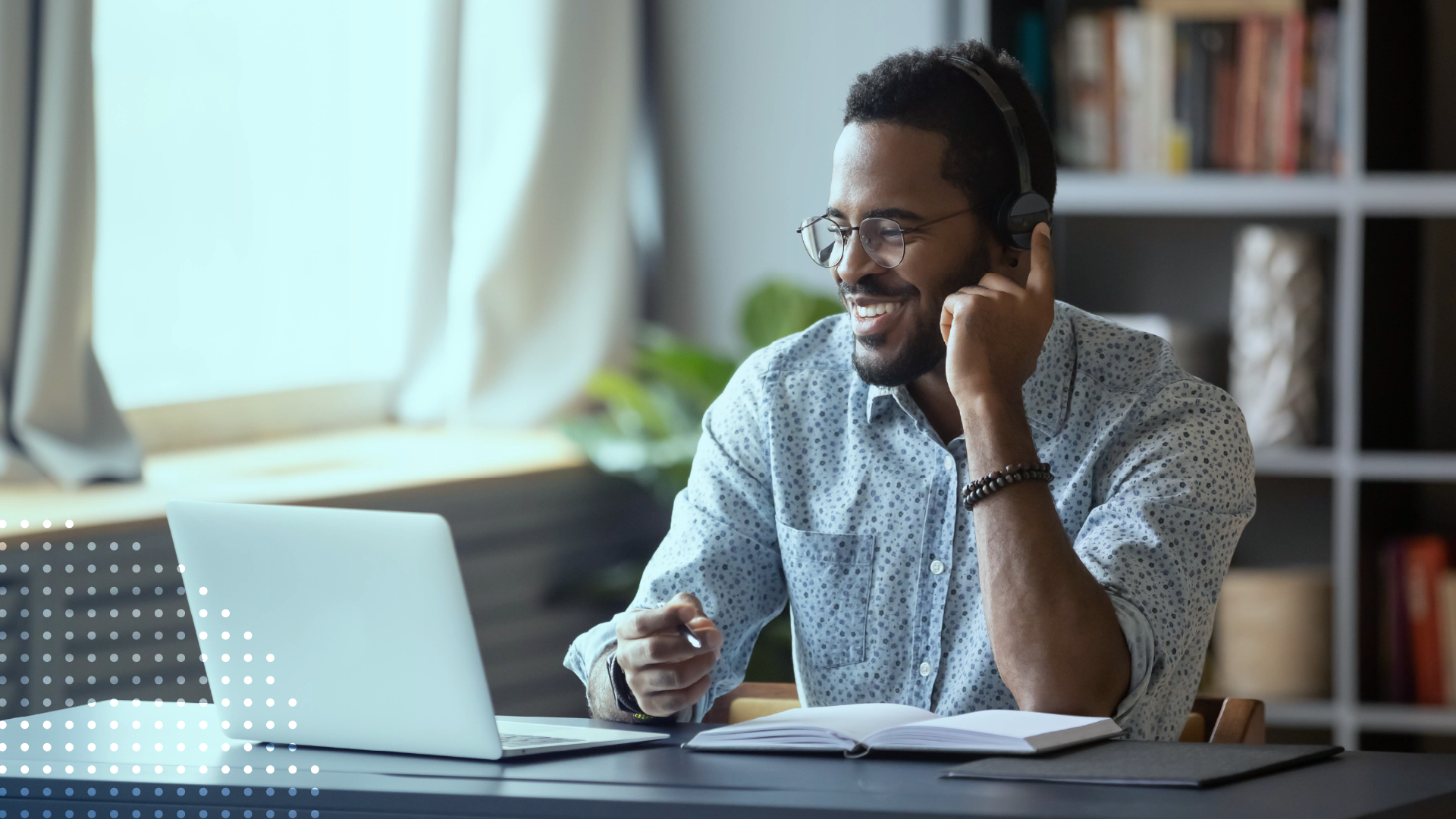 Man wearing headphones while taking an online course on a laptop.